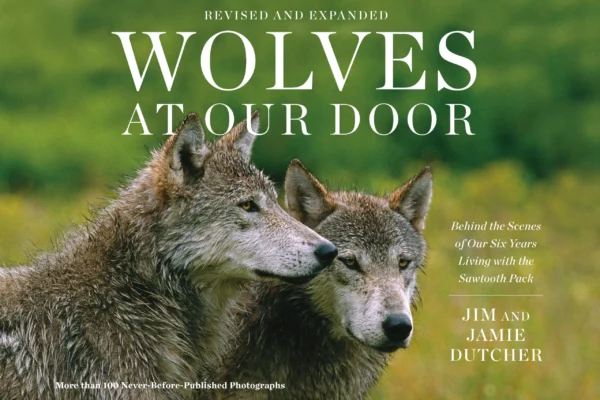 Book cover for the Wolves at Our Door product by Jim and Jamie Dutcher, featuring a photograph of two wolves side-by-side. | Living with Wolves